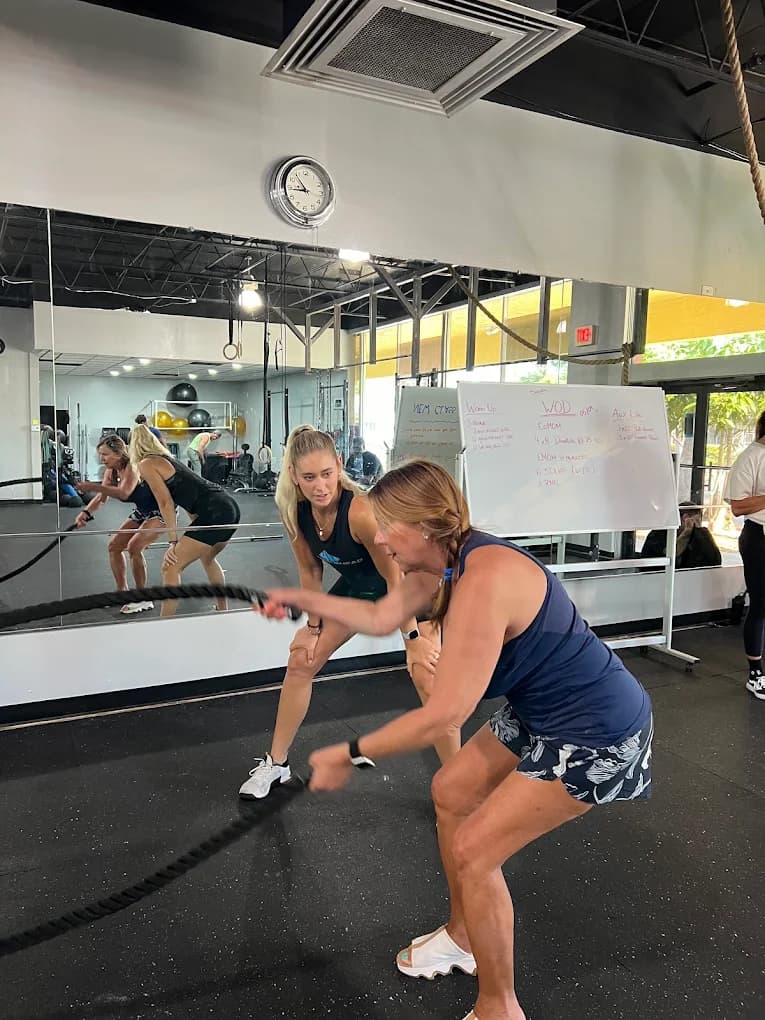 Members training with battle ropes on the Hammerhead Gym floor in Cape Coral.